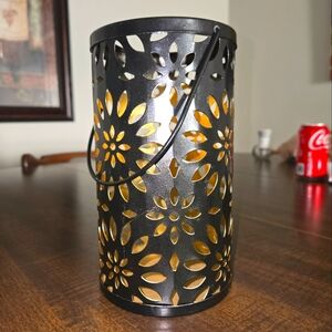 Black Metal Candle Holder With Desins all Throughout The Metal
